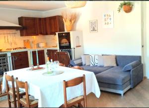 a living room with a table and a blue couch at Casa Ewa in Fiavè