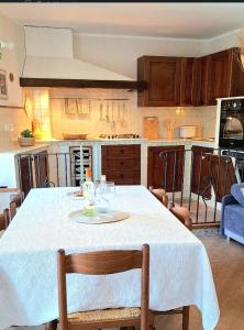 a kitchen with a table with a white table cloth at Casa Ewa in Fiavè +13 photos