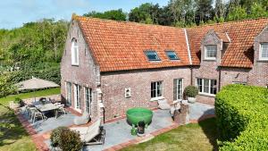an aerial view of a brick house with a patio at House C - North Sea Stays in De Haan +28 photos