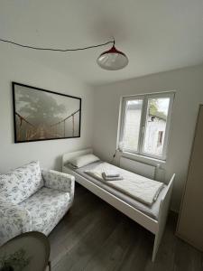 a room with a bed and a couch and a window at Work & Stay - Monteurzimmer - FeWo am NOK in Rendsburg