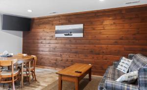 a living room with a wooden wall at Big Spirit Resort in Spirit Lake
