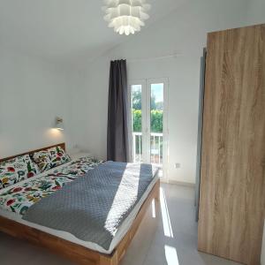 a bedroom with a large bed and a window at Bungalow Gran Canaria Oasis in Maspalomas +16 photos