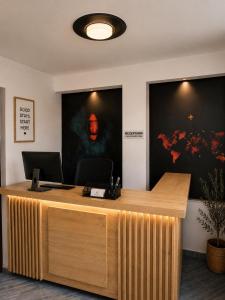 an office cubicle with a desk with a laptop computer at Sea Hotel in Ksamil