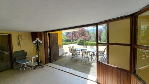a room with a balcony with a table and chairs at Chalet Pico Frentes in Cidones +23 photos