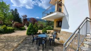 a patio with a table and chairs and a balcony at Chalet Pico Frentes in Cidones