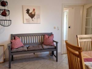 a bench with pillows on it in a room at Apfelblüte - Ferienhaus - ABC321 in Klein Warin