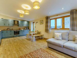 a living room with a couch and a kitchen at 2 Bed in Usk- oc-87285 in Llandenny