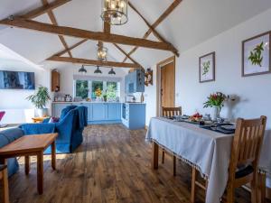 a living room with a table and a kitchen at 1 Bed in Axminster oc-82604 in Chardstock