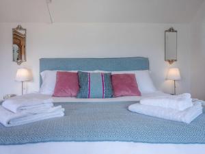 a bed with a bunch of towels on it at 1 Bed in Axminster oc-82604 in Chardstock