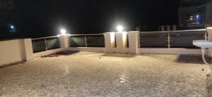 a balcony at night with a sink and lights at Orchard Suite in VÄngaon