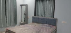 a bedroom with a bed and a mirror and curtains at Orchard Suite in VÄngaon +21 photos