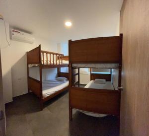 a room with two bunk beds in a room at FinlandHouse in Puerto López +18 photos