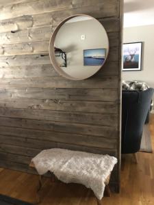 a mirror on a wooden wall in a living room at Gårdens Stugor - stugor för självhushåll in Klimpfjäll