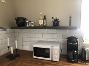a microwave sitting on the floor in a kitchen at Gårdens Stugor - stugor för självhushåll in Klimpfjäll
