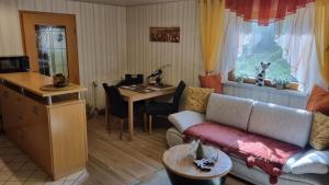 a living room with a couch and a table at Ferienwohnung Sonnenblick in Bischofswerda