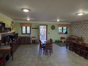 a living room with a table and chairs and a kitchen at Podveský mlýn in Tlumačov