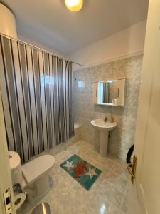 a bathroom with a toilet and a sink at Summer Comfort Apartment in Nea Kallikrateia +38 photos