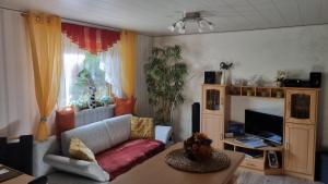 a living room with a couch and a table at Ferienwohnung Sonnenblick in Bischofswerda