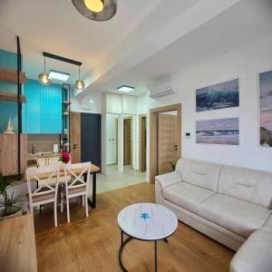 a living room with a couch and a table at Olive residence A8 in Petrovac na Moru