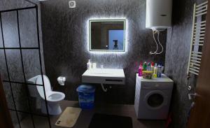a bathroom with a sink and a washing machine at Prishtina Host in Prishtinë +38 photos