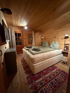 a bedroom with a bed in a wooden cabin at ChaletFeeling im Salzkammergut in Strobl