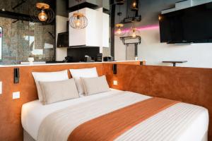 a bedroom with a large bed with two pillows at Cap Cosy studio standing Naturiste Heliopolis Cap d'Agde with Sea View in Cap d'Agde