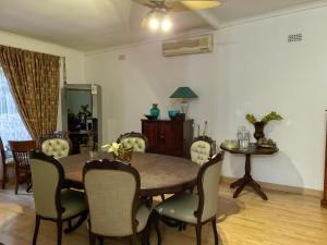 a dining room with a table and chairs at Ronique's Guest House in Rustenburg