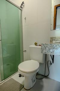a bathroom with a toilet and a glass shower at Vila Fox Estadia in Lençóis +31 photos
