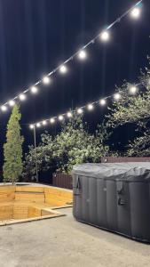 a stage with lights and a table and some trees at Mini House in Shahumyan