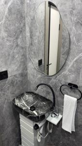 a bathroom with a marble sink and a mirror at Mini House in Shahumyan +4 photos