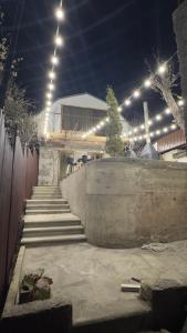 a set of stairs in front of a building with lights at Mini House in Shahumyan