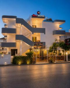 a large white building with a sign on it at Sea Hotel in Ksamil