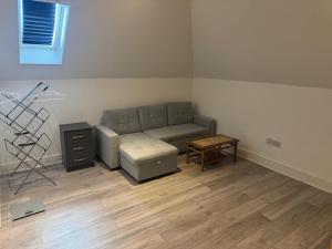 a living room with a couch and a table at Epsom High Street Apartment 9 in Epsom +2 photos