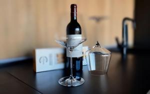 a bottle of wine and a glass on a table at Design apartmán in Teplice