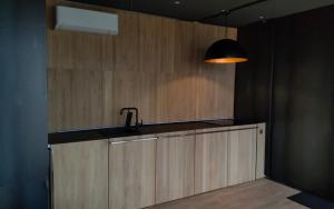 a kitchen with a sink and a black lamp at Design apartmán in Teplice +41 photos