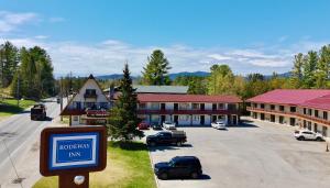 a small town with cars parked in a parking lot at Rodeway Inn Lake Placid South in Lake Placid