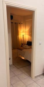 a bedroom with a bed and a lamp in a room at Port Breeze Apartments in Karlovasi