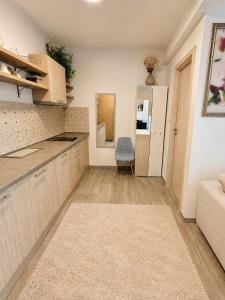a kitchen with a counter and a chair in a room at Blue Bay Studio in Bečići