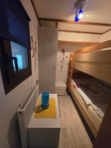 a room with two bunk beds and a blue cup on a table at Mobilheim Chalet Chicco in Steinach
