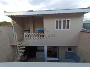 a balcony of a house with a staircase at Harmonia e Paz in São José dos Campos