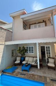 a house with a pool in front of it at Harmonia e Paz in São José dos Campos