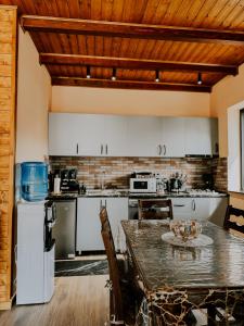 a kitchen with a table and a counter top at Omenor Kazbegi in Kazbegi