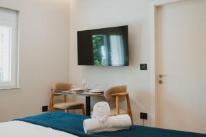 a bedroom with a table and a television on the wall at Shehu Skenderbeg Stay in Tirana
