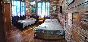 a bedroom with a bed in a brick wall at Hotel Tierra Verde in Bocas Town +78 photos