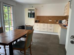 a kitchen with a wooden table and chairs in it at Ruhige Monteurwohnung Ohrtermersch in Bippen