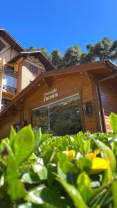 a building with a sign on the front of it at Pousada Jasmim in Gramado