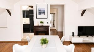 a living room with a white table and a tv at Haus OS in Bischofshofen