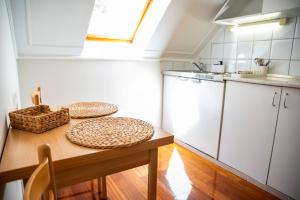 a small kitchen with a table with two plates on it at Mooi Panzió in Nagyatád