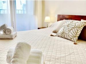 a bedroom with a large bed with white sheets and pillows at Il Moro di Ossuna in Trapani