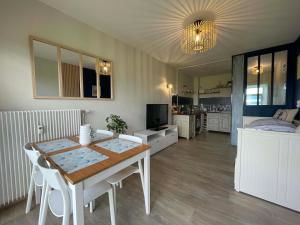 a living room with a table and a bedroom at Studio face mer L'escapade marine in Calais +16 photos
